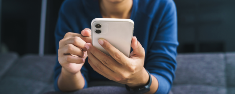 Person using a smartphone to access online banking services for secure, convenient mobile banking. Easily manage accounts, pay bills, and transfer funds anytime, anywhere with Northwoods Credit Union's mobile and online banking solutions.