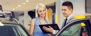 A person shopping for a car at a dealership after getting pre-approved for an auto loan from a credit union.