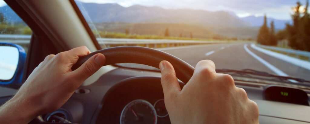 Hands on Steering Wheel Image | Northwoods Credit Union Driver’s hands on a steering wheel inside a car - Truck Loan Refinancing at NCU
