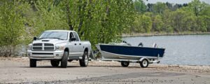 Truck and Boat Image 1 | Northwoods Credit Union Placing boat in a Minnesota lake after securing a boat loan.